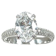 an oval cut diamond ring with pave set shoulders