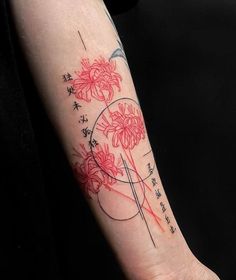 a woman's arm with red flowers and chinese characters on it, in front of a black background