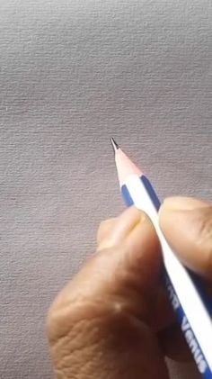 a person holding a pencil in their left hand