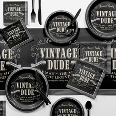 an assortment of vintage dude dinnerware and place settings on a black tablecloth with white lettering