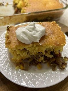 a piece of pie sitting on top of a white plate next to a casserole dish