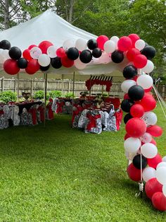 an outdoor party setup with balloons and decorations