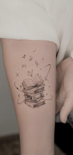 Beautiful book tattoos ideas for readers, tattoos for readers, meaningful tattoos, books tattoos, book tattoos tiny, book tattoos small, book tattoos sleeve, patchwork tattoos ideas, stack of books tattoos, book tattoos ideas simple, fine line art tattoo, book tattoos ideas small, meaningful literary tattoos for book lovers, book tattoos for literature lovers. Flying Books Tattoo, Old Books Tattoo, Unique Book Lover Tattoos, Stack Book Tattoo, Book Magic Tattoo, Book Friend Tattoos, Book With Tree Tattoo, Fine Line Tattoo Book, Bookish Sleeve Tattoo