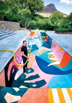 a man standing in front of a colorful pool