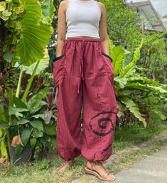 "The harem style trousers made from cotton fabric 100%with an elasticated smock waist and ankles they provide a comfortable lightweight fit, perfect for casual wear, festivals, yoga, holidays as well as pairing with a plain top to get that popular look. Materials: Cotton Sizing: One size fits most. Size : (inches) ✿Waist : 22-42 inch ( 55-106 cm ) ✿ Hip :up to 49 inch ( 124 cm) ✿ Length 40\" ( 101 cm ) ✿2 sides pockets S I Z E : US SIZE 4 - 12 , UK SIZE 8 - 16 , EU SIZE 36 - 44 MODEL SIZE : size Casual Cotton Harem Yoga Pants, Bohemian Cotton Pants With Pockets, Hippie Cotton Bottoms For Meditation, Casual Cotton Harem Pants For Yoga, Baggy Cotton Pants For Meditation, Relaxed Fit Harem Pants With Pockets For Festivals, Bohemian Cotton Harem Pants With Relaxed Fit, Cotton Harem Yoga Pants, Bohemian Harem Pants With Pockets