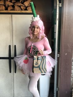 a woman dressed in pink and white holding a starbucks bag