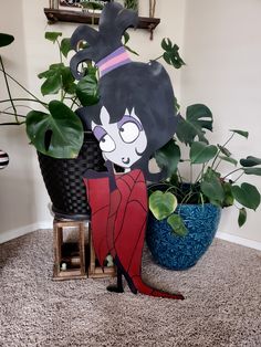 a paper cut out of an anime character next to some plants and potted plants