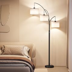 a bedroom with a bed and a lamp on the wall