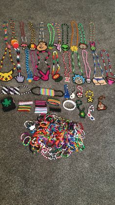 a pile of assorted necklaces and bracelets on the floor next to each other