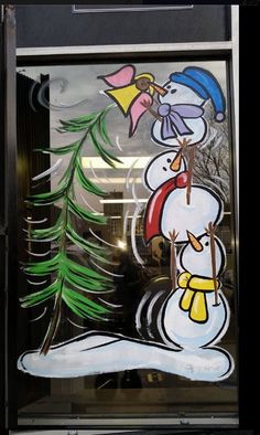 a frosted glass window with a snowman holding a christmas tree