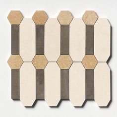 a white and brown tiled wall with hexagonal shapes