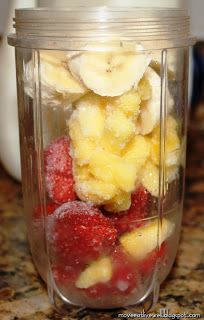 a blender filled with bananas and strawberries on top of a granite countertop