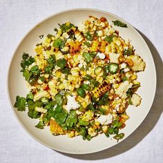 a white bowl filled with food on top of a table