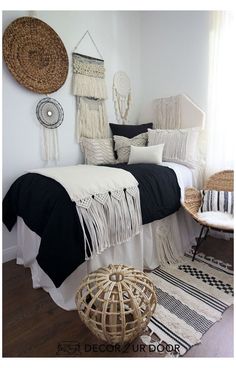 a white bedroom with black and white decor on the wall, wicker bed frame