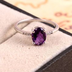 This Sterling Silver Ring features an Elegant Art With Natural Amethyst Gemstone. The cavity is made from genuine solid 925 sterling silver and stamped as S925. This Jewelry is Lead free and Rhodium plated to resist scratches and tarnish. ITEM DESCRIPTION Item Code: JARG335/7 Metal: 925/92.5 Sterling Silver Gemstone: Genuine Natural Amethyst Gemstone Shape: Oval Gemstone Size: 6 X 8 MM Oval Surrounded Tiny Stones: Zircon Ring Length: 8 MM Ring width: 6 MM Weight: 1.7 gm approx **Keep the jewelry Oval Amethyst Ring, February Birthstone Ring, Purple Ring, Ring Purple, Purple Rings, Tiny Rings, Midi Ring, Purple Band, Gold Earrings Designs