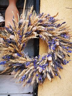 a dried wreath on the side of a building