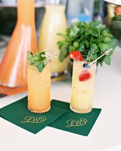 two drinks sitting on top of green napkins