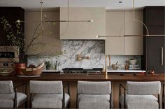 a kitchen with marble counter tops and chairs