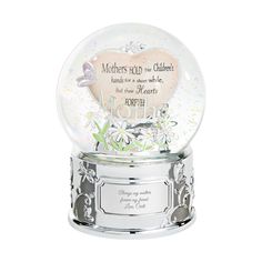 a snow globe with flowers and butterflies on the bottom, in front of a white background