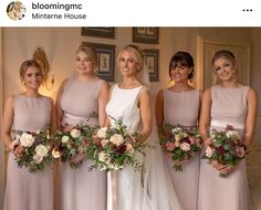 a group of women standing next to each other holding bouquets