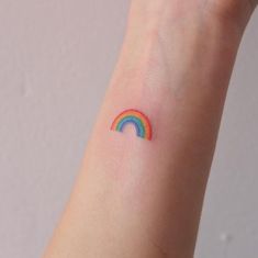 a small rainbow tattoo on the wrist