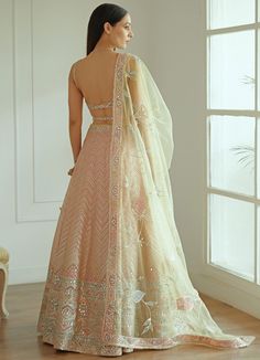 Features a soft pastel pink organza lehenga with heavy mirror work and gota patti embroidery. Styled with a strappy organza embroidered blouse and an elegant dupatta with mirror work and gota patti detailing. Included in the set is the embroidered belt that completes the ensemble Composition : Organza And Net Care: Dry Clean Only and Vacuum Storage This product can be customised for sleeves, length of blouse and neckline Delivery : 6-8 weeks as the product is hand crafted. For more information and sizes please contact fabiliciousfashion@gmail.com or visit our Copenhagen studio. Peach Georgette Lehenga With Zari Work, Semi-stitched Peach Lehenga With Sheer Dupatta, Peach Lehenga With Sheer Dupatta, Semi-stitched, Pink Organza Choli With Gota Work, Peach Lehenga With Mirror Work And Traditional Drape, Semi-stitched Peach Choli With Sheer Dupatta, Peach Semi-stitched Choli With Sheer Dupatta, Designer Peach Lehenga With Mirror Work, Peach Dupatta With Mirror Work For Reception