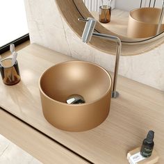 a bathroom sink sitting under a round mirror