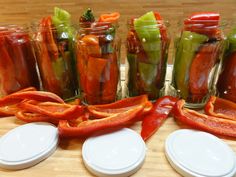 several jars filled with pickles and peppers