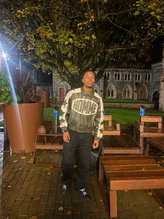 a man standing in front of some benches