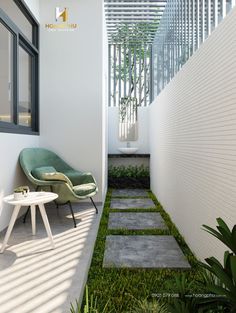 a chair and table sitting on the side of a white wall next to a small garden