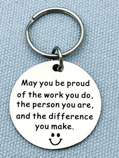 a keychain with a quote on it that says, may you be proud of the work you do, the person you are, and the difference you make