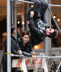 a man hanging upside down on a bike