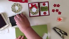 someone is making christmas wreaths on the wall with their cell phone and other decorations