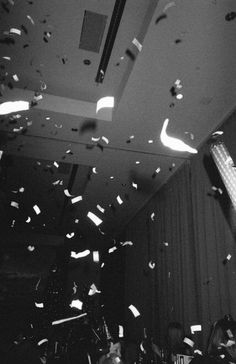 black and white photograph of confetti falling from the ceiling