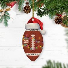 a football ornament hanging from a christmas tree