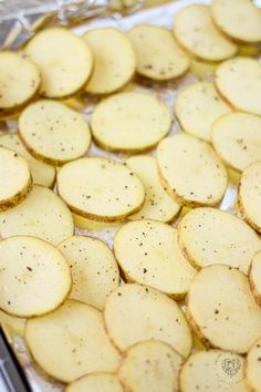 sliced potatoes on a baking sheet ready to be cooked in the oven for dinner time