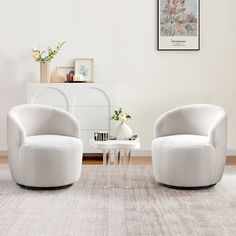 two white chairs sitting next to each other on top of a carpeted room floor