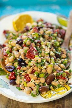 a white plate topped with beans and veggies