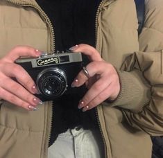 a woman holding a camera in her hands