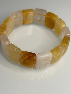 The Golden Healer Bangle, with its 17mm  square soft design, offers several benefits: Size: 17CM - Facilitates spiritual growth and inner transformation. - Promotes healing on all levels - physical, emotional, and spiritual. - Enhances clarity of thought and intuition. - Supports overall well-being and vitality. Its soft bangle design ensures comfortable wear while harnessing the powerful healing energy of the golden healer crystal. Adjustable Rectangular Crystal Bracelet As A Gift, Adjustable Rectangular Crystal Bracelet For Gift, Adjustable Rectangular Crystal Bracelet Gift, Inner Transformation, Golden Healer Quartz, Bangle Design, Golden Healer, Soft Design, Bangle Designs