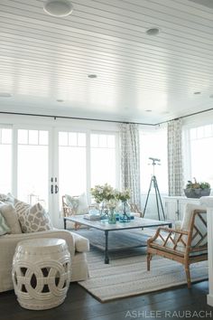 a living room filled with furniture and lots of windows