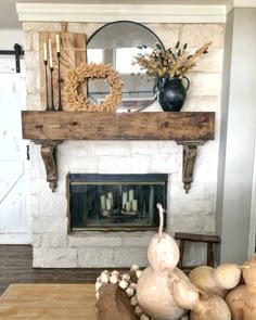 a living room filled with furniture and a fire place in front of a mantle topped with flowers