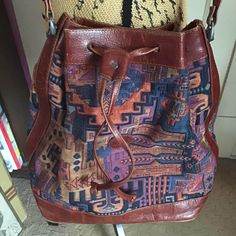 "Vintage 1980's 1990's genuine *Kilim* crossbody/shoulder bag. Beautiful multi-color fabric and genuine leather. Has one inside large main compartment with one inside zippered slip pocket. Has a genuine leather drawstring closure.  *SCROLL DOWN FOR CONDITION & MEASUREMENTS* CONDITION: I note a small area inside the bag that shows slight wear to the lining (SEE PIX). The inside zippered pocket is missing the zipper pull piece. On the bottom of the bag around the edge there is some slight wear and shows up like fade areas. Very superficial scratches here and there on the leather trim. SOLD AS IS!! MEASURES: Length excluding strap~12\" Width~13\" Bottom of bag~10\" X 6 1/2\" Strap is adjustable~20\"--->26\" *WE APOLOGIZE~BUT WE CAN NO LONGER SHIP TO GERMANY, ITALY OR SPAIN. IF ORDERS COME IN Kilim Bag, Hippie Bags, Color Fabric, Crossbody Shoulder Bag, Leather Trims, Bag Making, Fabric Color, Purses And Handbags, Multi Color