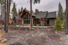 a house in the woods surrounded by trees