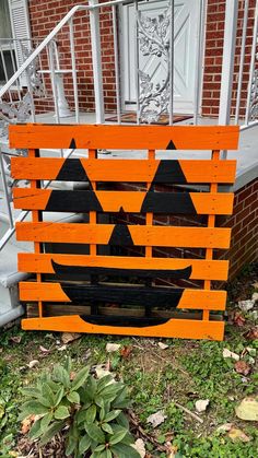 a wooden pallet with a jack - o'- lantern face painted on it