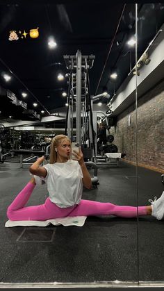 a woman sitting on the ground in front of a mirror