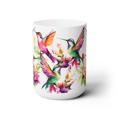 a white mug with colorful hummingbirds painted on it