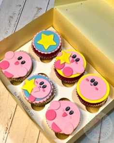 some cupcakes are in a box with stars and moon designs on them for someone's birthday