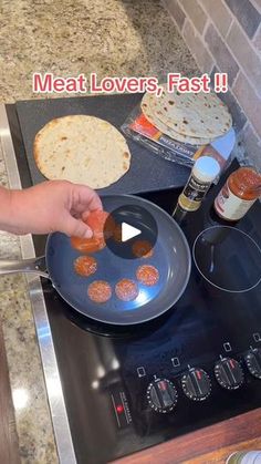 a person is cooking food on the stove with an oven mitt in front of them