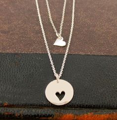 "An adorable gift for a mother and daughters. This set includes both the large pendant with heart cut outs, as well as small heart charm necklaces that fit right in place. A cute way to wear and remember the love for your little (or big) ones always. Perfect for back to school! This Mother Daughters necklace set includes: ~ Sterling Silver Round Disc Pendant with Double Heart Cut Outs ~ (16mm x 13mm) ~ Sterling Silver Tiny Heart Charms 10mm x 7mm ~ 16\" Sterling Silver Cable Chain (for Daughter) Mother's Day Open Heart Necklace With Charms, Double Heart Charms Necklace For Mother's Day, Mother Daughter Necklaces, Mother Daughter Necklaces Set, Tiny Heart Necklace, Mother Daughter Necklace, Daughter Jewelry, Sterling Silver Heart Pendant, Three Daughters